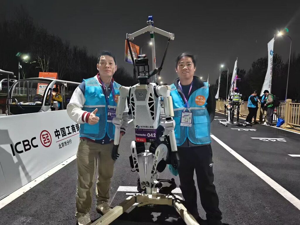 Team members with the Tien Kung humanoid during the night test