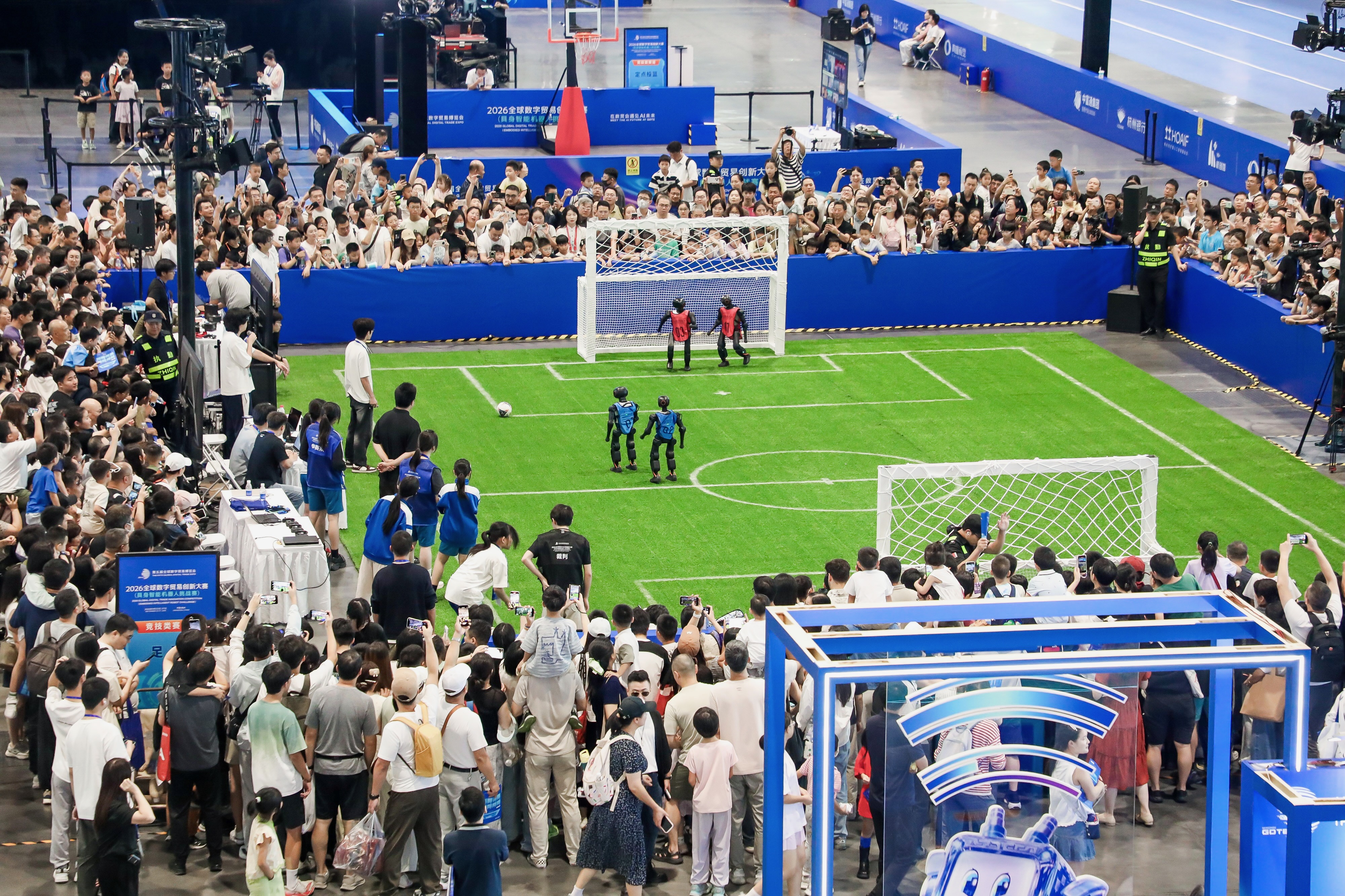 Spectators gathered around the robot soccer competition
